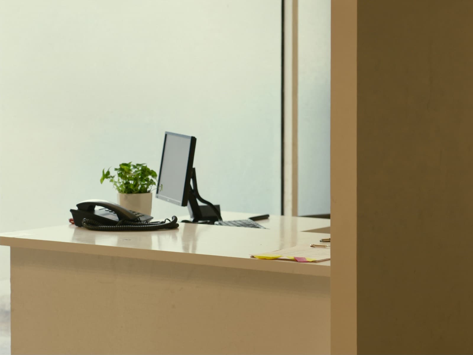 An unattended dental practice reception desk with a telephone on it